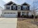 Charming two-story home with a two-car garage, landscaped yard, and covered front porch at 228 Heatherland Dr, Rock Hill, SC 29732