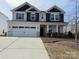 Charming two-story home with a two car garage, manicured lawn and stone accents at 228 Heatherland Dr, Rock Hill, SC 29732