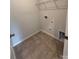 Well-lit laundry room with tile flooring, utility connections, and a clean, functional space at 228 Heatherland Dr, Rock Hill, SC 29732