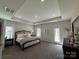Main bedroom featuring a tray ceiling, recessed lighting, neutral colors, and an en-suite bathroom at 228 Heatherland Dr, Rock Hill, SC 29732