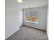 Neutral bedroom features a large window overlooking the neighborhood and plush carpeting at 246 Tail Race Ln, Fort Mill, SC 29715