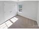 Bright bedroom featuring neutral carpet, a large closet, and a window providing natural light at 246 Tail Race Ln, Fort Mill, SC 29715