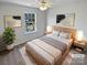 Serene bedroom with contemporary decor, a comfortable bed, and ample natural light, perfect for restful nights at 246 Tail Race Ln, Fort Mill, SC 29715