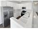 Modern kitchen featuring white cabinetry, stainless steel appliances, and a functional layout for cooking at 246 Tail Race Ln, Fort Mill, SC 29715