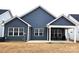 Backyard view featuring siding, a covered patio with furniture, and a well-maintained lawn area at 2617 Manor Stone Way, Indian Trail, NC 28079