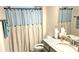 Well-lit bathroom with granite countertop, mirror and shower with stylish blue and beige curtain at 2617 Manor Stone Way, Indian Trail, NC 28079
