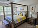 Spacious bedroom with a four-poster bed, natural light, and neutral decor at 2617 Manor Stone Way, Indian Trail, NC 28079