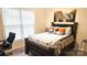 Cozy bedroom with a large window, comfortable bed, and stylish decor at 2617 Manor Stone Way, Indian Trail, NC 28079