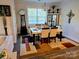 Bright dining room with modern lighting, a dining table for six, and large window at 2617 Manor Stone Way, Indian Trail, NC 28079