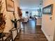 Inviting entryway view showcases the home's open-concept design with wood floors and modern decor at 2617 Manor Stone Way, Indian Trail, NC 28079