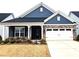 Charming home featuring a stone and shingle facade with a two-car garage and well-manicured landscaping at 2617 Manor Stone Way, Indian Trail, NC 28079