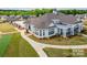 Aerial view of the clubhouse showcasing its architectural design, beautiful landscaping and surrounding greenery at 2617 Manor Stone Way, Indian Trail, NC 28079