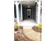 Inviting entryway with a covered porch, stone accents, and a decorative front door at 2617 Manor Stone Way, Indian Trail, NC 28079