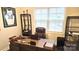 Comfortable home office with a large wooden desk, ergonomic chair, and ample natural light at 2617 Manor Stone Way, Indian Trail, NC 28079