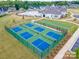 Aerial view of community tennis and pickleball courts, with clubhouse and pool in the background at 2617 Manor Stone Way, Indian Trail, NC 28079
