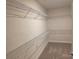 Walk-in closet with extensive shelving provides ample storage space at 2617 Manor Stone Way, Indian Trail, NC 28079