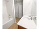 Clean bathroom with a single sink vanity, a bathtub with shower, and neutral-toned flooring at 2643 Meadow Knoll Dr, Charlotte, NC 28269