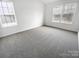Bright bedroom featuring neutral carpet and natural light from two large windows at 2643 Meadow Knoll Dr, Charlotte, NC 28269