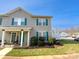 Charming townhouse with green shutters, well-maintained landscaping, and inviting front porch on a sunny day at 2643 Meadow Knoll Dr, Charlotte, NC 28269