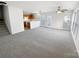 Open concept living area with fresh carpet and an adjacent kitchen at 2643 Meadow Knoll Dr, Charlotte, NC 28269