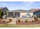 Well-maintained backyard with a patio area, fire pit, and lush landscaping at 305 Hemlock Bluff Ct, Denver, NC 28037