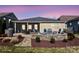 Beautiful patio and backyard with a custom fire pit and manicured landscaping at 305 Hemlock Bluff Ct, Denver, NC 28037