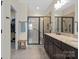 Sleek bathroom features a glass shower, a double vanity, and a walk-in closet at 305 Hemlock Bluff Ct, Denver, NC 28037