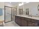 Modern bathroom featuring a double vanity, large mirror, and a glass shower at 305 Hemlock Bluff Ct, Denver, NC 28037
