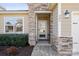 Inviting front entrance with stone accents, paved walkway, and well-maintained landscaping at 305 Hemlock Bluff Ct, Denver, NC 28037