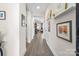 Long hallway with hardwood floors, decorative shelving, and access to multiple rooms at 305 Hemlock Bluff Ct, Denver, NC 28037