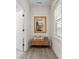 Hallway featuring hardwood floors, a wooden bench, and decorative accents at 305 Hemlock Bluff Ct, Denver, NC 28037