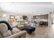 Open-concept living room flows into the kitchen, with a large sofa and hardwood floors at 305 Hemlock Bluff Ct, Denver, NC 28037