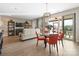 Bright living room with a ceiling fan, sliding glass doors to a screened porch, and a dining area at 305 Hemlock Bluff Ct, Denver, NC 28037