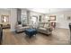 Cozy living room featuring neutral tones, plush seating, stylish decor, and ample natural light at 305 Hemlock Bluff Ct, Denver, NC 28037