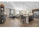Open-concept living space with hardwood floors and granite island and plenty of natural light at 305 Hemlock Bluff Ct, Denver, NC 28037