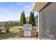 Outdoor stone grill on a patio surrounded by mature landscaping at 305 Hemlock Bluff Ct, Denver, NC 28037