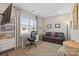 Well-lit workspace featuring a large window, modern furniture, and comfortable seating area at 305 Hemlock Bluff Ct, Denver, NC 28037