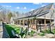 Inviting backyard features a covered patio, outdoor seating, and a cozy fire pit for entertaining at 324 Patternote Rd, Mooresville, NC 28117