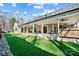Large covered patio with built-in outdoor kitchen and string lights at 324 Patternote Rd, Mooresville, NC 28117