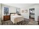Bedroom featuring a large window, hardwood floors, and an ensuite bathroom at 324 Patternote Rd, Mooresville, NC 28117