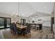 Elegant dining room with a wooden table and modern chandelier, open to the kitchen at 324 Patternote Rd, Mooresville, NC 28117
