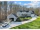 Beautiful two-story home with a three car garage, matching boat garage and lush green yard at 324 Patternote Rd, Mooresville, NC 28117