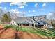 Back exterior of home with covered porch and large yard at 324 Patternote Rd, Mooresville, NC 28117