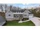 Charming front exterior features a brick base, cozy porch, and walkway to a three car garage at 324 Patternote Rd, Mooresville, NC 28117