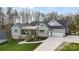 Attractive gray craftsman home featuring a covered porch, brick accents, and a two-car garage at 324 Patternote Rd, Mooresville, NC 28117