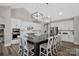 Stylish kitchen boasts a black island with a marble countertop and modern white cabinetry at 324 Patternote Rd, Mooresville, NC 28117