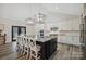 Spacious kitchen island with marble countertop and stylish chairs adjacent to modern appliances at 324 Patternote Rd, Mooresville, NC 28117