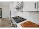 Close-up of a modern gas stovetop with white subway tile backsplash in a bright kitchen at 324 Patternote Rd, Mooresville, NC 28117