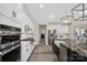 Well-appointed kitchen featuring stainless steel appliances and sleek white cabinetry with great lighting at 324 Patternote Rd, Mooresville, NC 28117