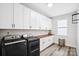 Modern laundry room with white cabinets, wooden countertop, new appliances, and bright lighting at 324 Patternote Rd, Mooresville, NC 28117